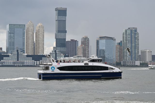 NYC Ferry cruises up the East River.
